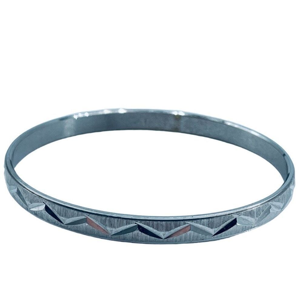 Vintage crown Trifari diamond cut silver colored bangle bracelet.